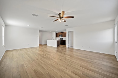 Unfurnished living room featuring visible vents, b