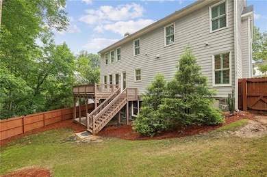 Back of house featuring a fenced backyard, a deck, and stairway