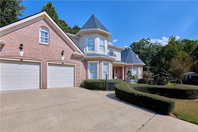 Victorian-style house featuring driveway, a garage