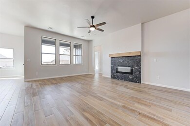 Unfurnished living room with ceiling fan and light