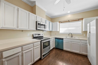 Kitchen with stainless steel appliances, a sink, w