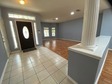 Foyer entrance with recessed lighting, light wood