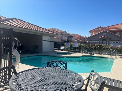 Community pool with a hot tub, a residential view,