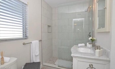 Newly updated bathroom with frameless shower door,