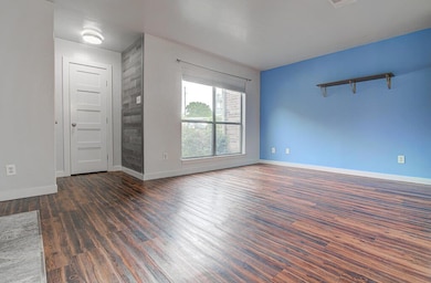 Empty room with visible vents, baseboards, and wo