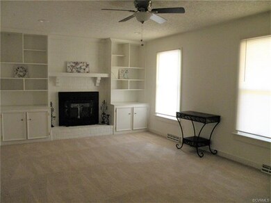 Living room with wood burning fireplace, built-in 