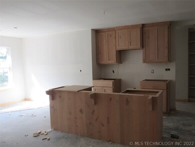 Kitchen features an island and will have granite c