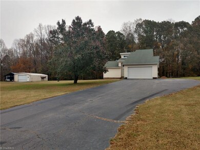 Front View of home with lots of parking and a paved driveway