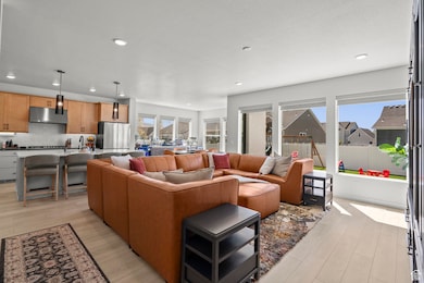 Living area with light flooring and recessed lighting