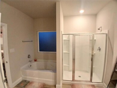 Bathroom featuring a stall shower and a garden tub