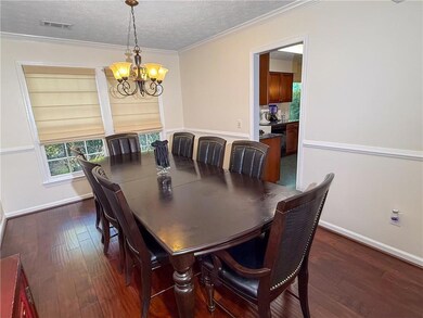 Dining room with baseboards, an inviting chandelie