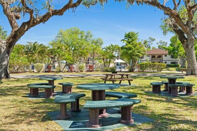 Picnic area with outdoor grills, benches, tables, and recreation courts are within view.