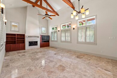 Unfurnished living room with high vaulted ceiling
