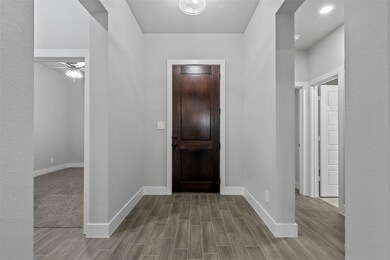 Foyer featuring ceiling fan and light hardwood / w