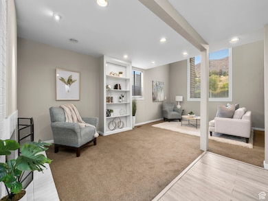 Sitting room featuring recessed lighting, light carpet, and light wood-type flooring