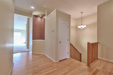 Hardwood entry with lighted statue niche and close