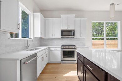 Kitchen featuring light countertops, a sink, ligh