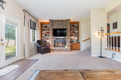 Living room featuring a fireplace, built in featur