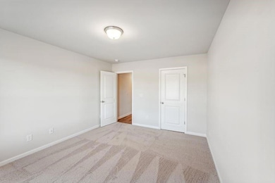 Spare room featuring light carpet