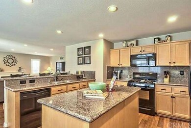 Kitchen with Breakfast Bar opens to Family Room.  