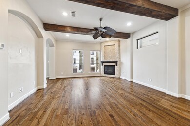 Spacious living area with gleaming wood floors, hi