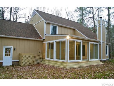 The back sunroom features multiple sliding doors o