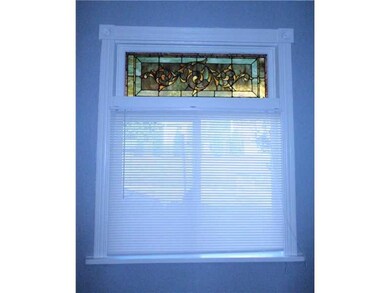 Living Room. Front window with original stained gl