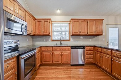 Kitchen has loads of cabinet space and lush hardwo
