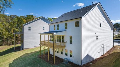 Back of house featuring a lawn, central air condit