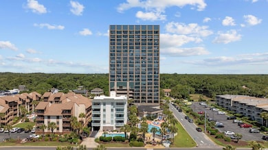 View of building exterior with uncovered parking a