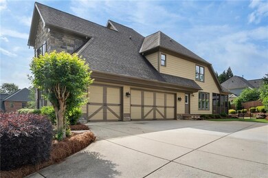 View of front of home with stone siding, fence, dr