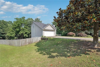 View of property exterior with driveway, an attached garage, and a chimney