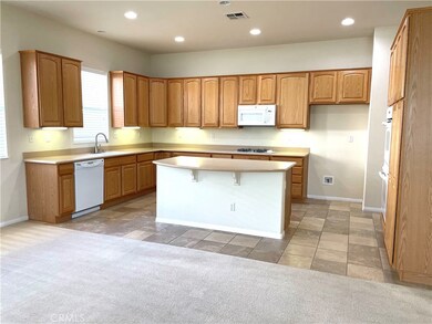 Large, open kitchen with solid surface countertops, double ovens, great for entertaining.