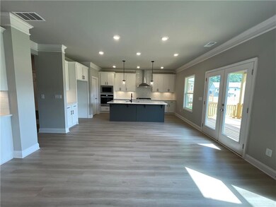 Kitchen with an island with sink, appliances with 