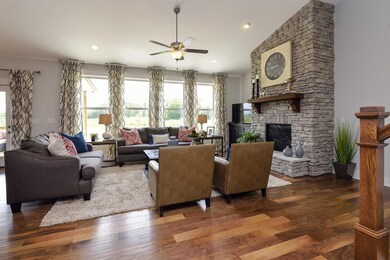 Great room with an amazing stacked stone fireplace! Photo for representation only. 