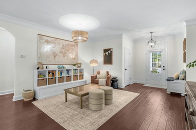 Living area featuring arched walkways, dark wood-s