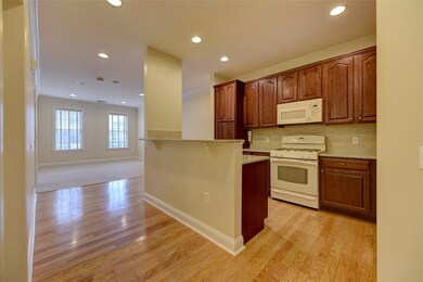 As you enter, you see the stylish kitchen, fully a