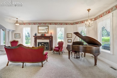 Formal sitting room with turret windows, antique fireplace mantle, gas fireplace and 1920s Baby Grand Piano