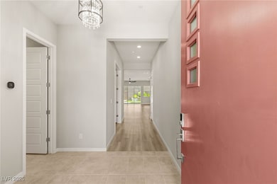 Corridor featuring a chandelier, recessed lighting