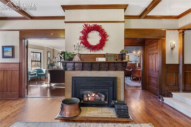 Grand Hallway with fireplace, living room to the l