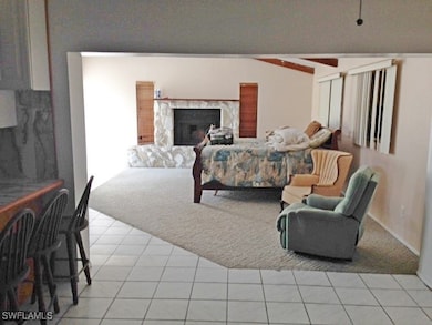 Dining area looking into living room with beamed c