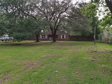 FRONT OF HOME WITH MATURE OAKS.