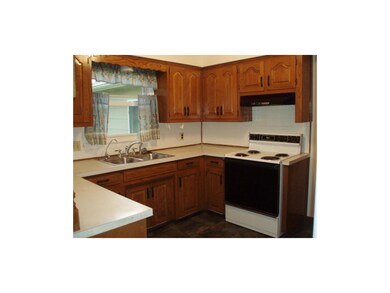 Kitchen. White ceramic tile walls and slate-look c