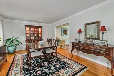Living Room features Wood floors, crown moulding, 