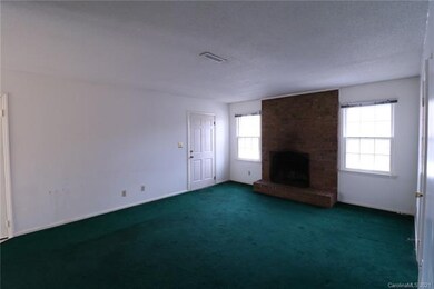 Entrance into the living room with full brick fire