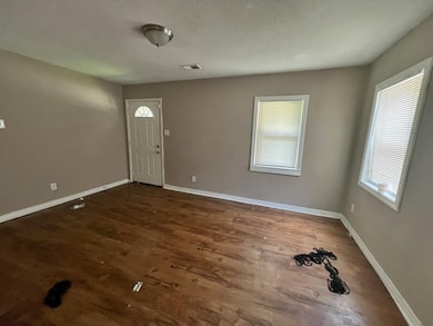 Entryway with baseboards and wood finished floors
