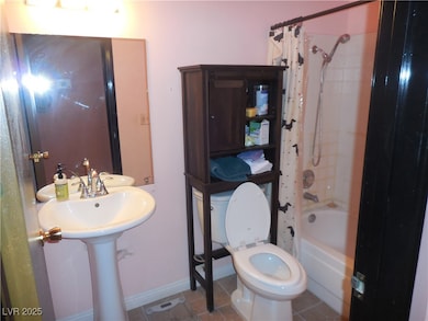 Full bath featuring shower and tile patterned floo