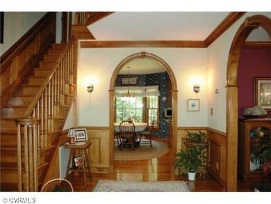 Foyer - Three Arched doorways in foyer. Oak stairw