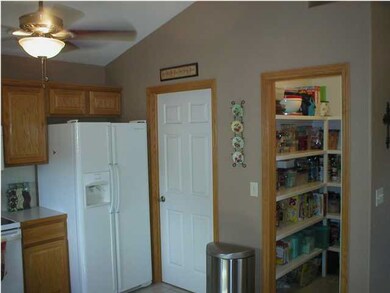 Kitchen leading to laundry. Pantry door open.