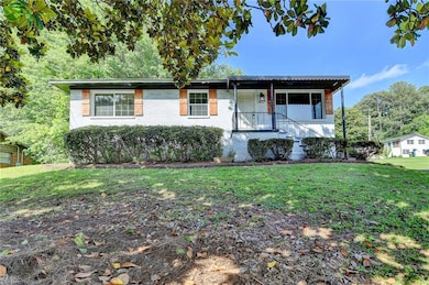 Ranch-style house featuring a front lawn and brick siding